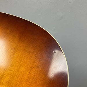 Close-up of a Waterloo WL-12 Parlor Acoustic w/Case (used, consign), featuring a sunburst finish and showing a small dent near the edge against a plain gray background.