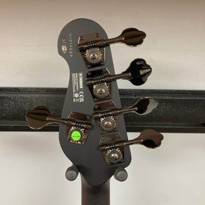 Close-up of the back of a Yamaha BB735A Electric 5-String Bass Coffee Sunburst (Blem Discount) headstock showing four tuning pegs, manufacturer labels, serial numbers, and a green "QC PASSED" sticker against a neutral background.