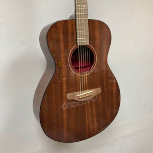 A Yamaha Storia III Solid Mahogany Top Concert guitar hangs on a white wall.
