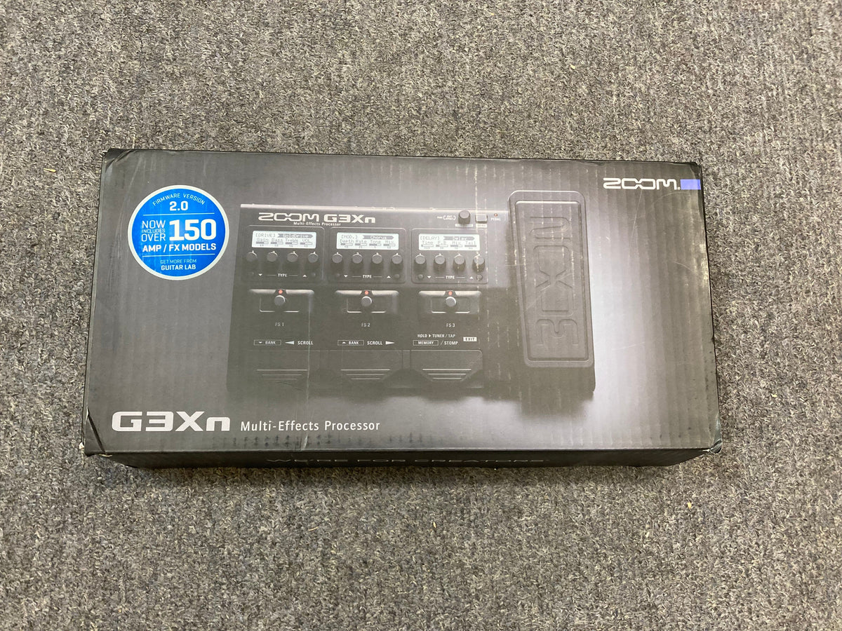 Zoom G3XN Guitar Multi Effects Processor USED, shown in its packaging, highlighting its versatile design with dials and built-in expression pedal for diverse sound experimentation.