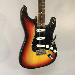 1976 Fender Stratocaster Sunburst, all original with original case and paperwork, displayed on a wall. Close-ups highlight guitar's neck, strings, and volume knob.