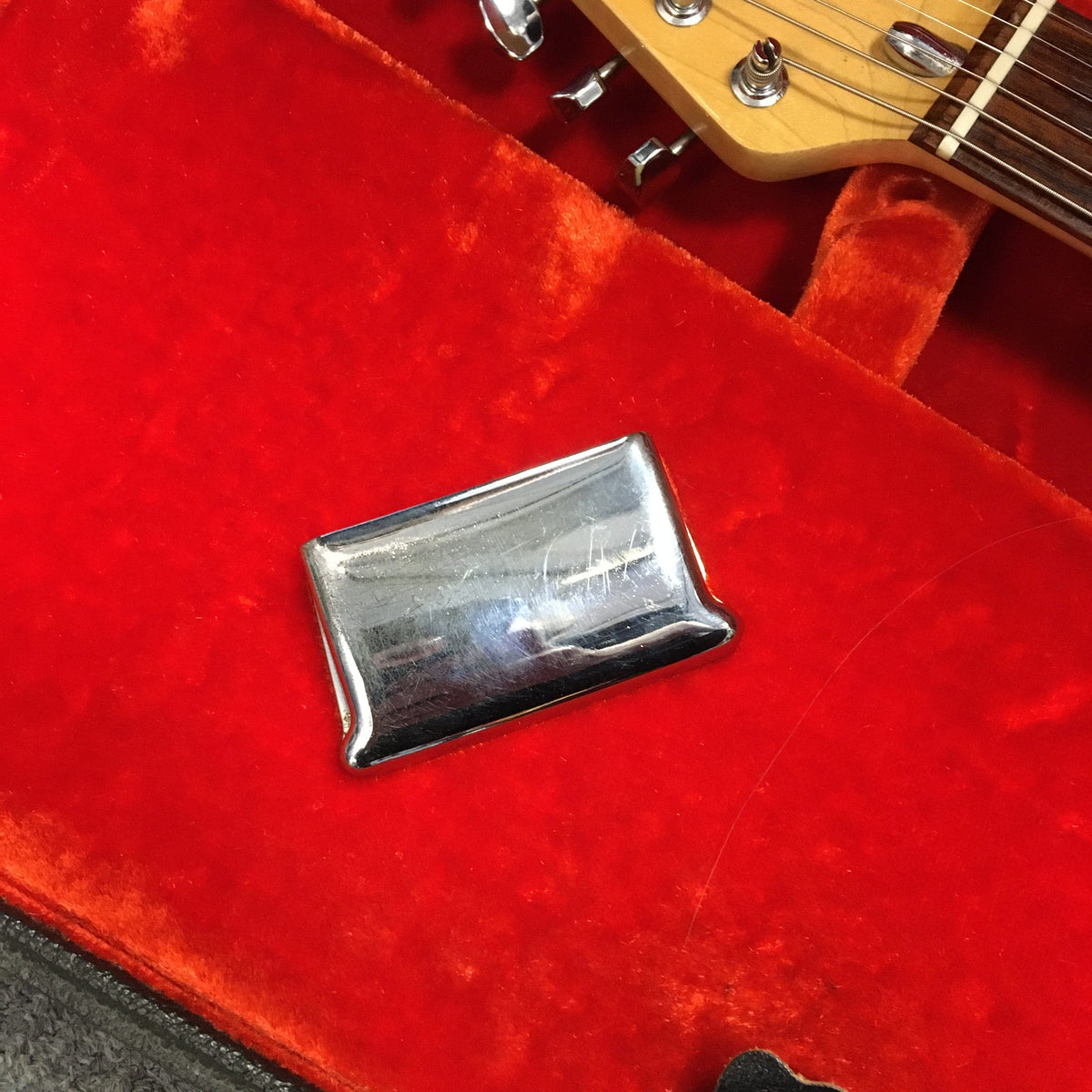 1976 Fender Stratocaster Sunburst, all original with case and paperwork, displayed on a red velvet case, showcasing its pristine condition.
