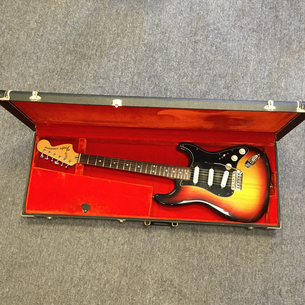 1976 Fender Stratocaster Sunburst in original case with paperwork and accessories, showcasing great condition and original parts.