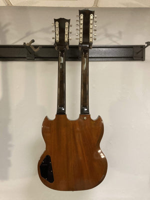 1980 Gibson EDS-1275 Double Neck Electric Guitar mounted on a wall, showcasing its iconic double-neck design and excellent condition.