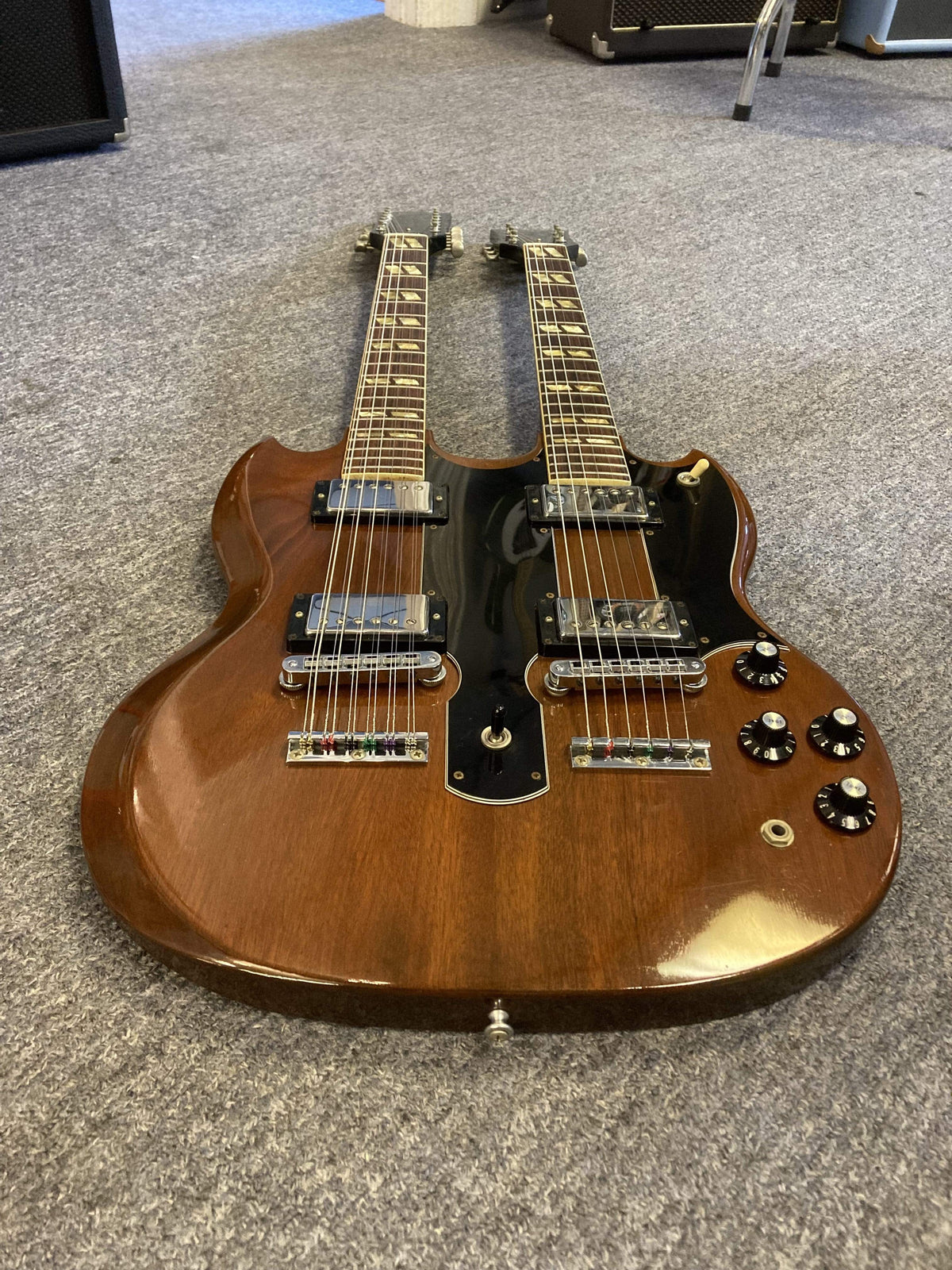 1980 Gibson EDS-1275 Double Neck Electric Guitar on a carpet, showcasing its iconic design and condition.