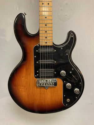 1980 Peavey T-27 Electric Guitar with double-cutaway body, maple neck, high gloss finish, b/w/b pickguard, and blade-style humbucker and single coil pickups.