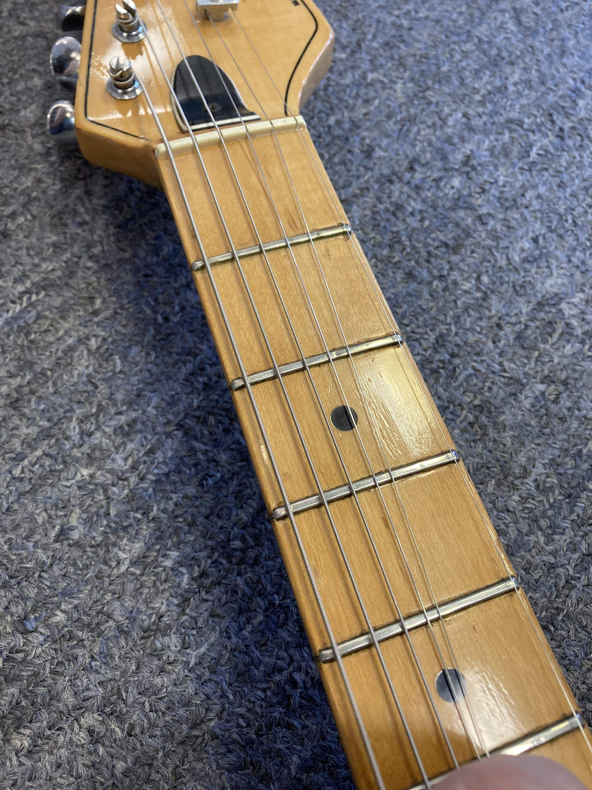 1980 Peavey T-27 Electric Guitar close-up showing strings, maple neck, and vintage double-cutaway body.
