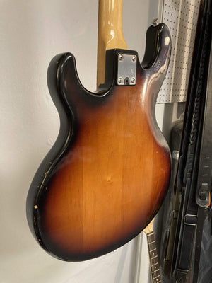 1980 Peavey T-27 Electric Guitar with double-cutaway body and maple neck, hanging on a wall.