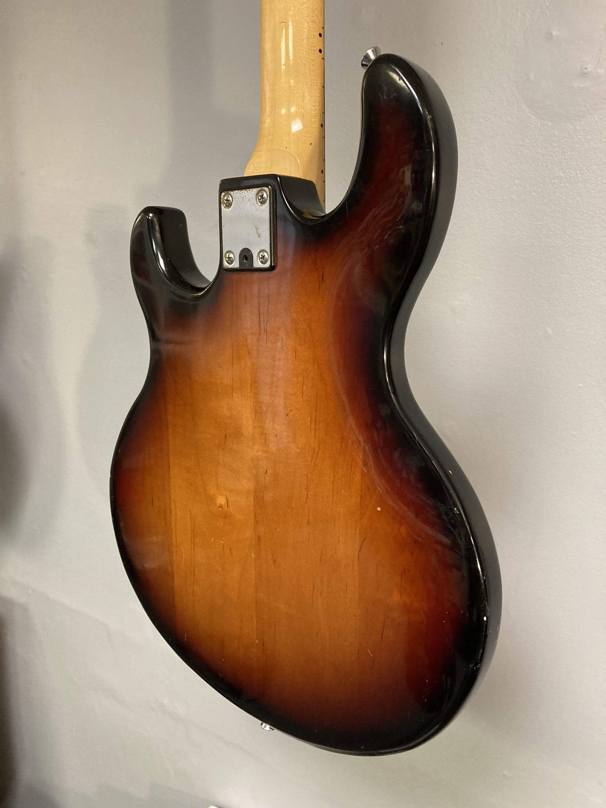 1980 Peavey T-27 Electric Guitar with double-cutaway body, maple neck, high gloss finish, and versatile pickups mounted on a wall.