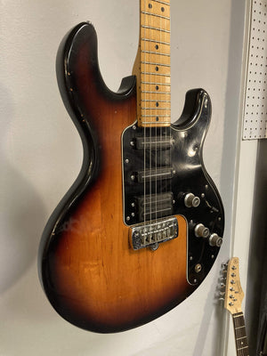 1980 Peavey T-27 Electric Guitar on wall, showcasing double-cutaway body, maple neck, and high gloss finish.