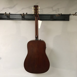 Art & Lutherie Americana Bourbon Burst guitar on display, showcasing its acoustic-electric features with integrated electronics and rosewood fingerboard, made for versatile performances.