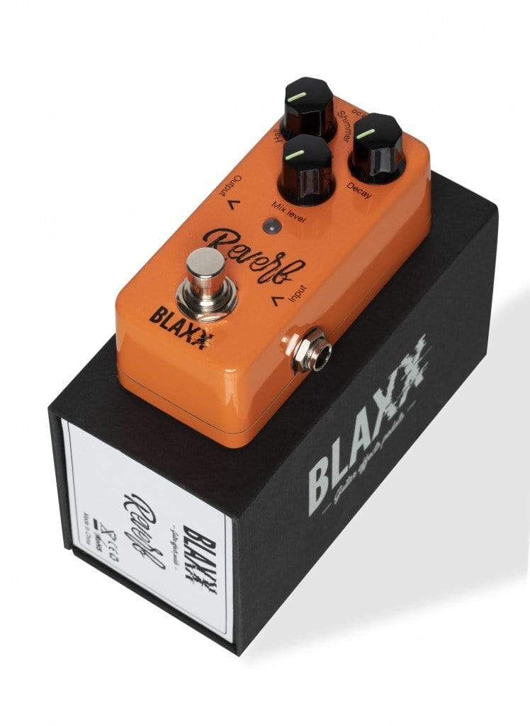 A used Blaxx Reverb Pedal for electric guitar with three black knobs, a metallic footswitch, and input/output jacks, shown on its branded box—ideal for adding rich reverb effects to your sound.