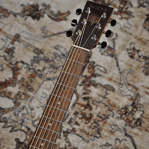 Bodhi BG10S Concert Body Acoustic Guitar featuring a close-up of the neck on a rug, showcasing solid spruce top and Merbau fretboard.
