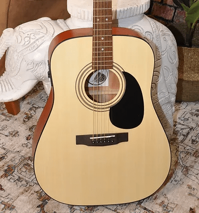 Bodhi BG20E Spruce Top Dreadnaught Body Acoustic-Electric Guitar placed on a rug, showcasing its detailed craftsmanship and robust build.