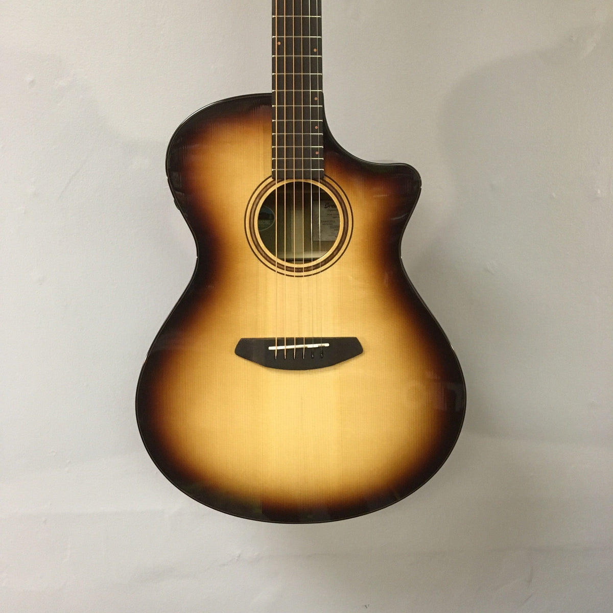 Breedlove Artista Pro Concerto Burnt Amber CE European-Myrtlewood guitar in a hardshell case, showcasing its detailed craftsmanship and premium materials.