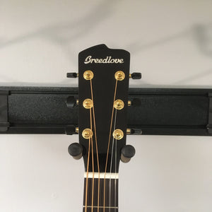 Breedlove Artista Pro Concerto Burnt Amber CE European-Myrtlewood guitar on a stand displaying strings and gold hardware.