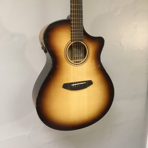 Breedlove Artista Pro Concerto guitar with European spruce top and myrtlewood sides, displayed on a wall.