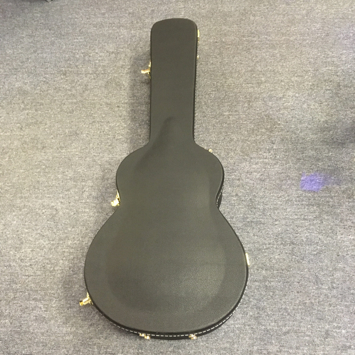 Breedlove Artista Pro Concerto Burnt Amber CE European-Myrtlewood guitar in a black hardshell case on a grey surface.