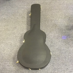 Breedlove Artista Pro Concerto Burnt Amber CE European-Myrtlewood guitar in a black hardshell case on a grey surface.