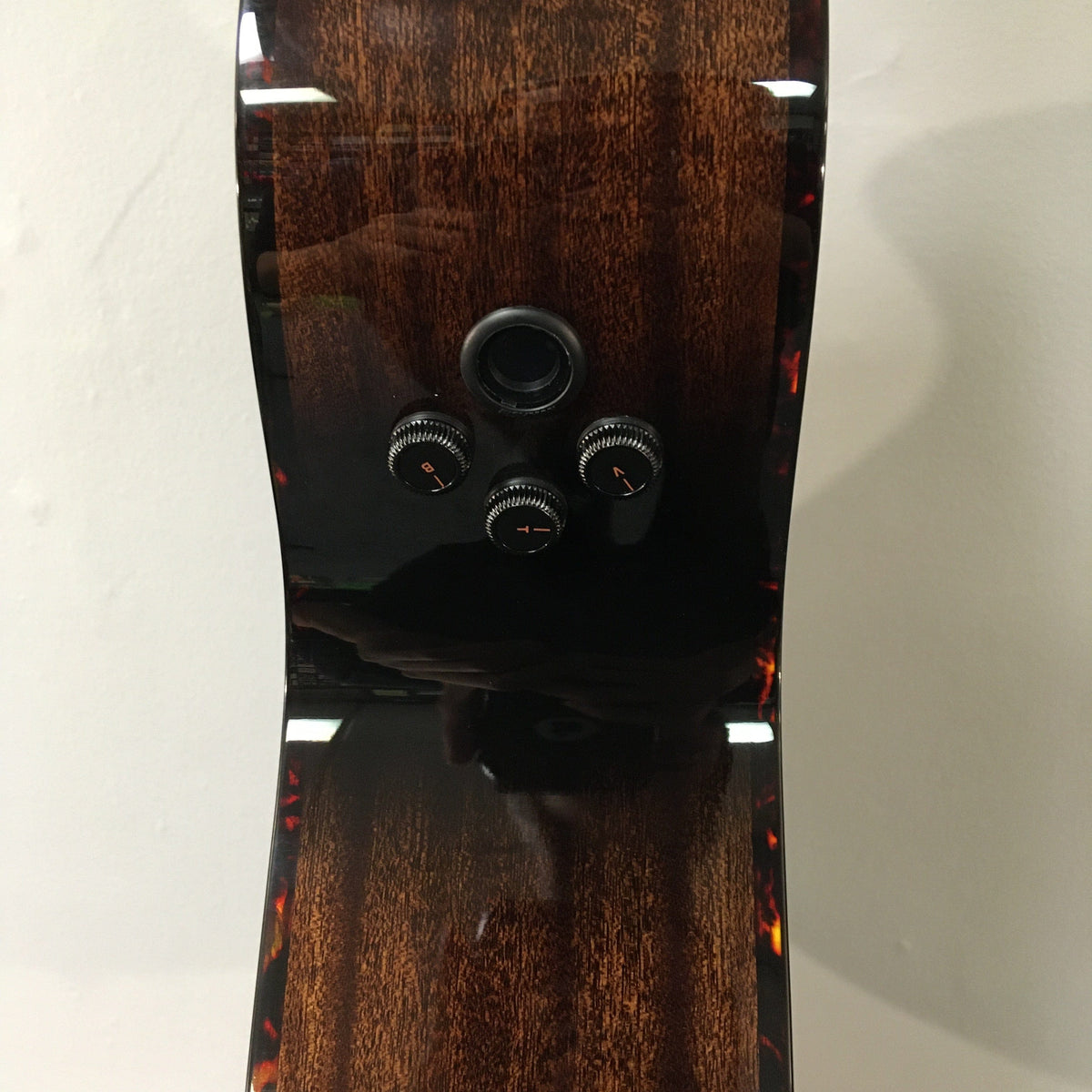 Breedlove Performer Pro Concert Aged Toner CE guitar, featuring African mahogany and European spruce, with knobs and dials for versatile play.