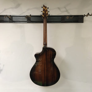 Breedlove Performer Pro Concert Aged Toner CE European-African Mahogany guitar mounted on a wall, showcasing its premium craftsmanship and solid wood construction.