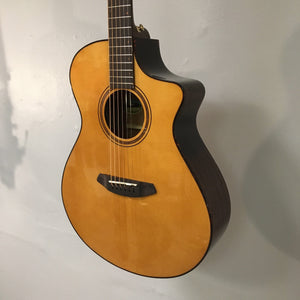 Breedlove Performer Pro Concert Aged Toner CE European-African Mahogany guitar displayed on a wall, showcasing its detailed craftsmanship and premium build quality.
