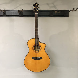 Breedlove Performer Pro Concert Aged Toner CE guitar with African mahogany and European spruce, displayed on a wall.