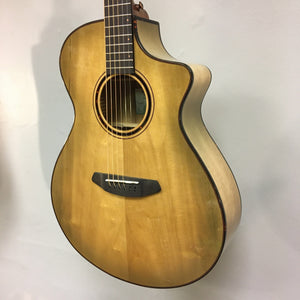 Close-up of the Breedlove Pursuit Exotic S Concert Sweetgrass CE B-Stock guitar, highlighting its intricate strings and tortoise binding.