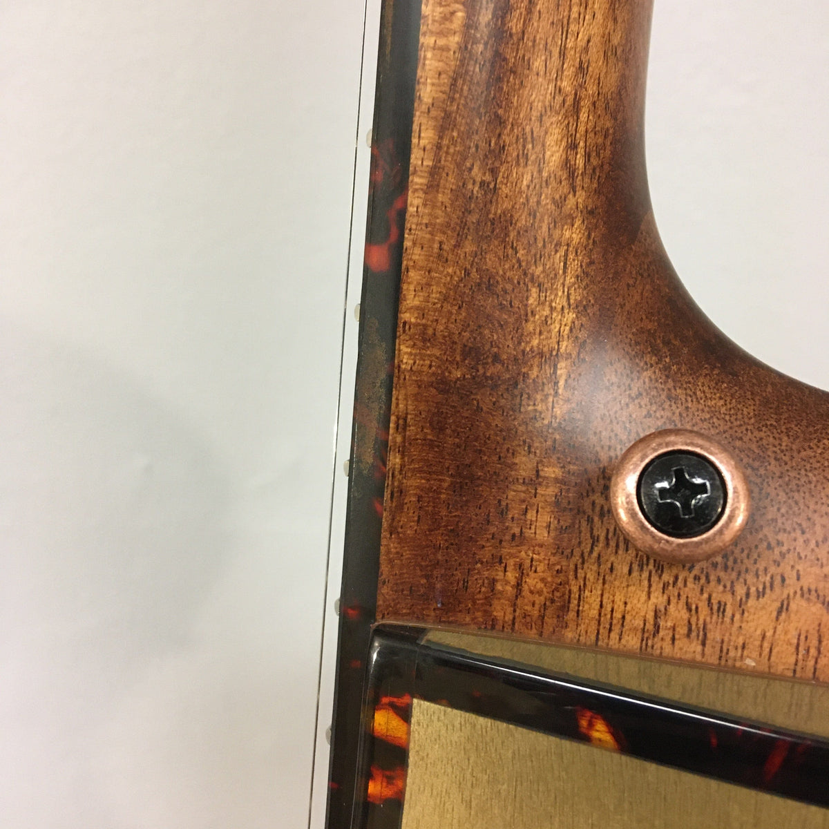 Close-up of a Breedlove Pursuit Exotic S Concert Sweetgrass CE B-Stock guitar, highlighting the intricate wood and metal components, including visible screws and premium craftsmanship.