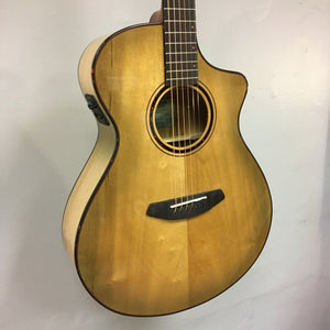 Close-up of a Breedlove Pursuit Exotic S Concert Sweetgrass CE B-Stock guitar, highlighting its strings and body details.