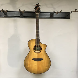 Breedlove Pursuit Exotic S Concert Sweetgrass CE B-Stock acoustic guitar displayed on a wall.