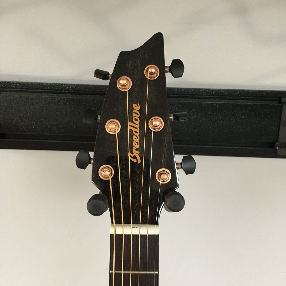 Breedlove Pursuit Exotic S Concert Sweetgrass CE B-Stock guitar head with gold lettering and visible guitar neck.