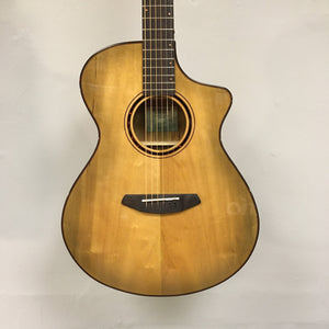 Close-up of a Breedlove Pursuit Exotic S Concert Sweetgrass CE B-Stock acoustic guitar, highlighting the strings and body craftsmanship.