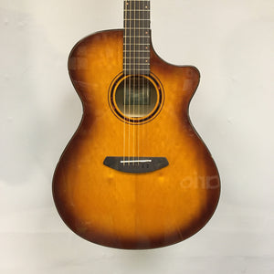 Close-up of a Breedlove Pursuit Exotic S Concerto CE Tiger's Eye Myrtlewood B-Stock acoustic guitar, highlighting the strings and tortoise-bound finish.