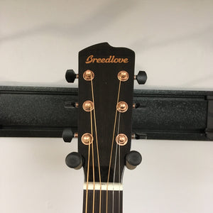 Close-up of the Breedlove Pursuit Exotic S Concerto CE Tiger's Eye Myrtlewood B-Stock guitar head with gold strings and copper tuners.