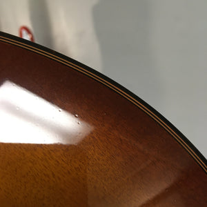 Close-up of a Breedlove Pursuit Exotic S Concerto CE Tiger's Eye Myrtlewood B-Stock guitar, highlighting the finish and minor binding blemishes.