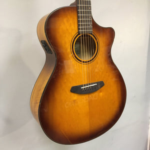 Breedlove Pursuit Exotic S Concerto CE Tiger's Eye Myrtlewood B-Stock acoustic guitar with visible finish blemishes on binding, hanging on a wall.