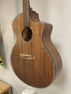 Breedlove Wildwood Concerto Satin CE guitar, close-up of solid African mahogany body and strings, highlighting craftsmanship and detail.
