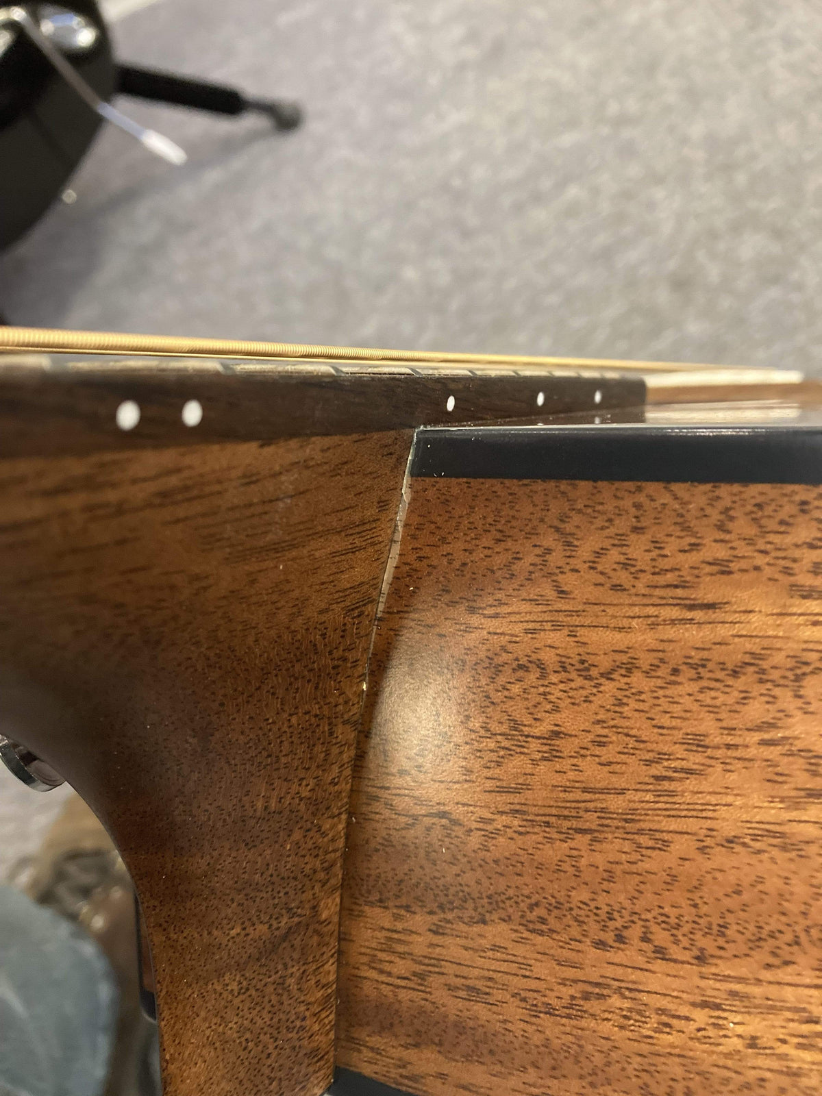 Breedlove Wildwood Concerto Satin CE Solid African Mahogany guitar close-up, showcasing the fine mahogany grain and craftsmanship.