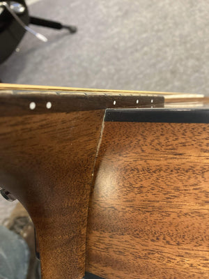 Breedlove Wildwood Concerto Satin CE Solid African Mahogany guitar close-up, showcasing the fine mahogany grain and craftsmanship.