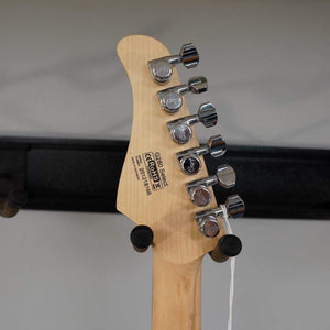 Cort G280 Select Trans Black guitar close-up showing headstock, pearloid pickguard, and chrome hardware.