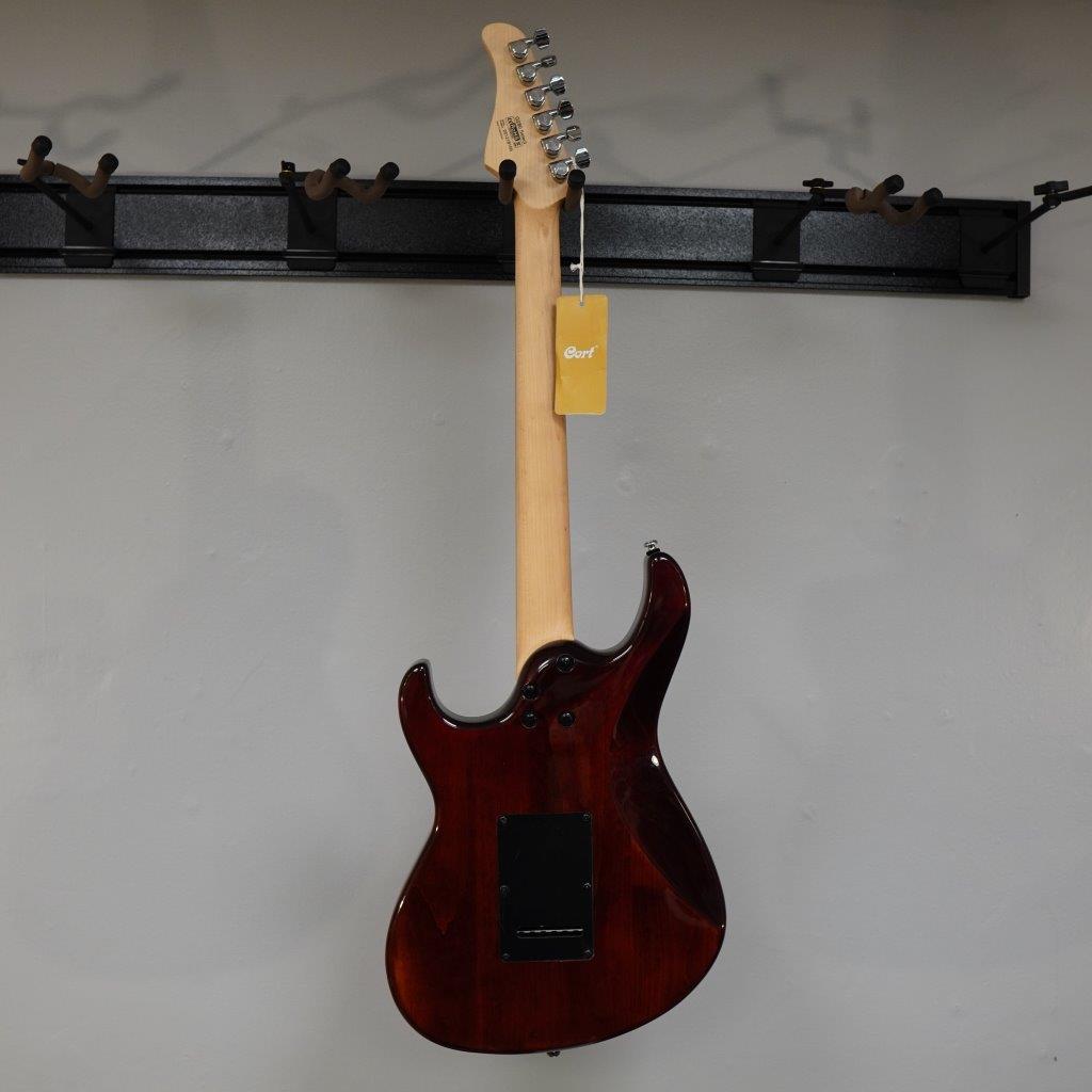 Cort G280 Select Trans Black electric guitar with pearloid pickguard and Rosewood fingerboard, displayed on a wall.