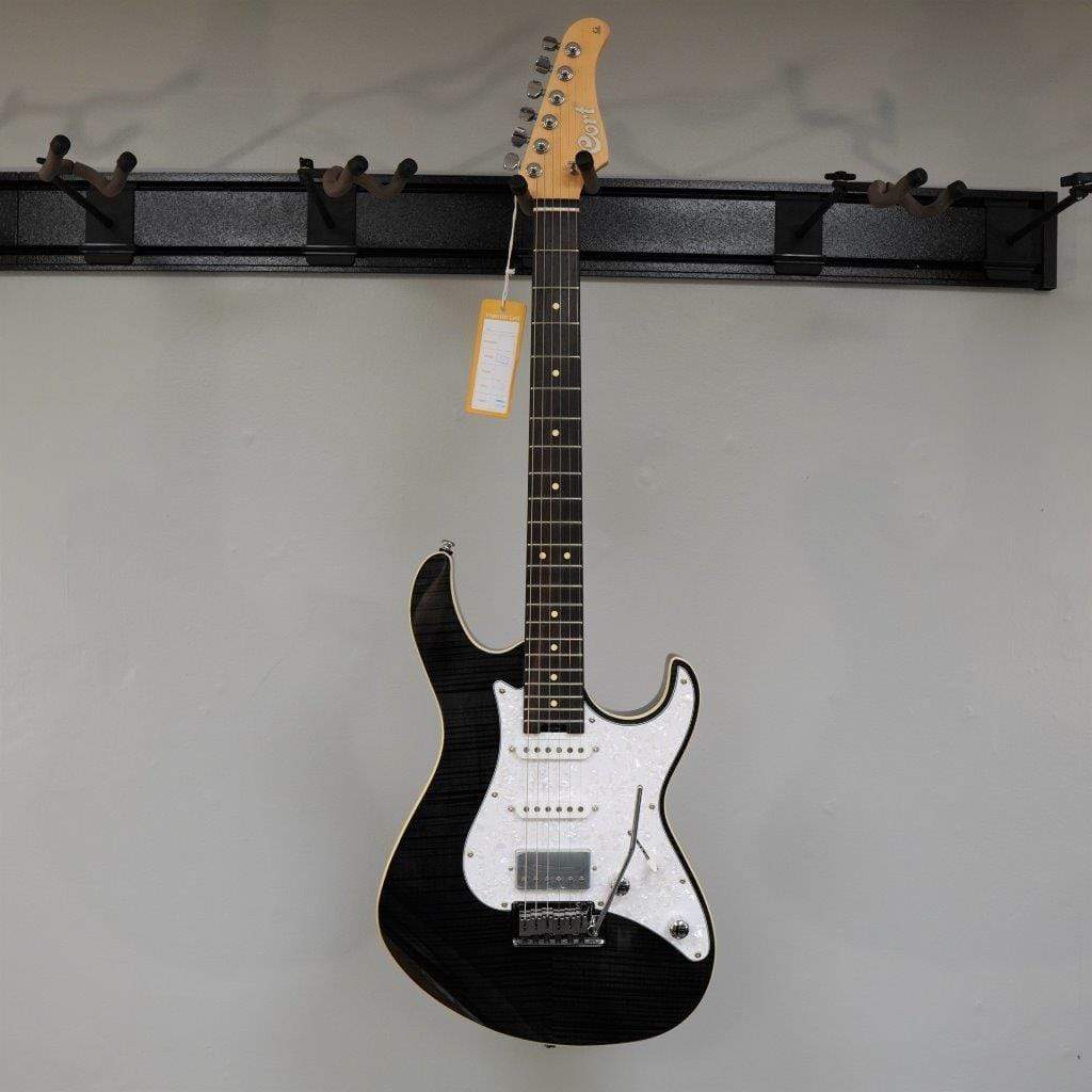 Cort G280 Select Trans Black electric guitar mounted on a wall, featuring a pearloid pickguard, Rosewood fingerboard, and Voiced Tone VTH-77 humbucker.
