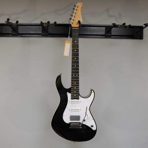 Cort G280 Select Trans Black electric guitar mounted on a wall, featuring a pearloid pickguard, Rosewood fingerboard, and Voiced Tone VTH-77 humbucker.