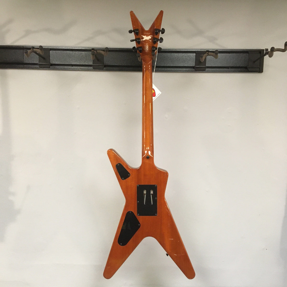 Dean Dimebag Dime Slime ML electric guitar with Floyd Rose tremolo, displayed on a wall.
