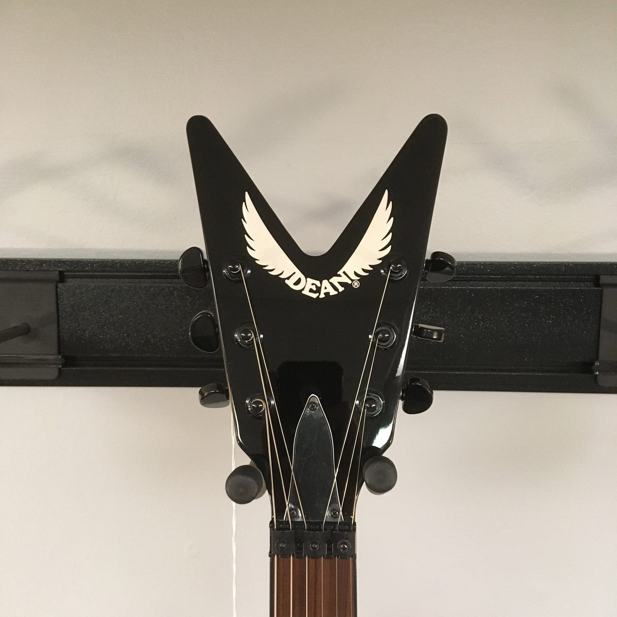 Dean Dimebag Dime Slime ML Electric Guitar on a stand with V profile neck and Floyd Rose tremolo bridge.