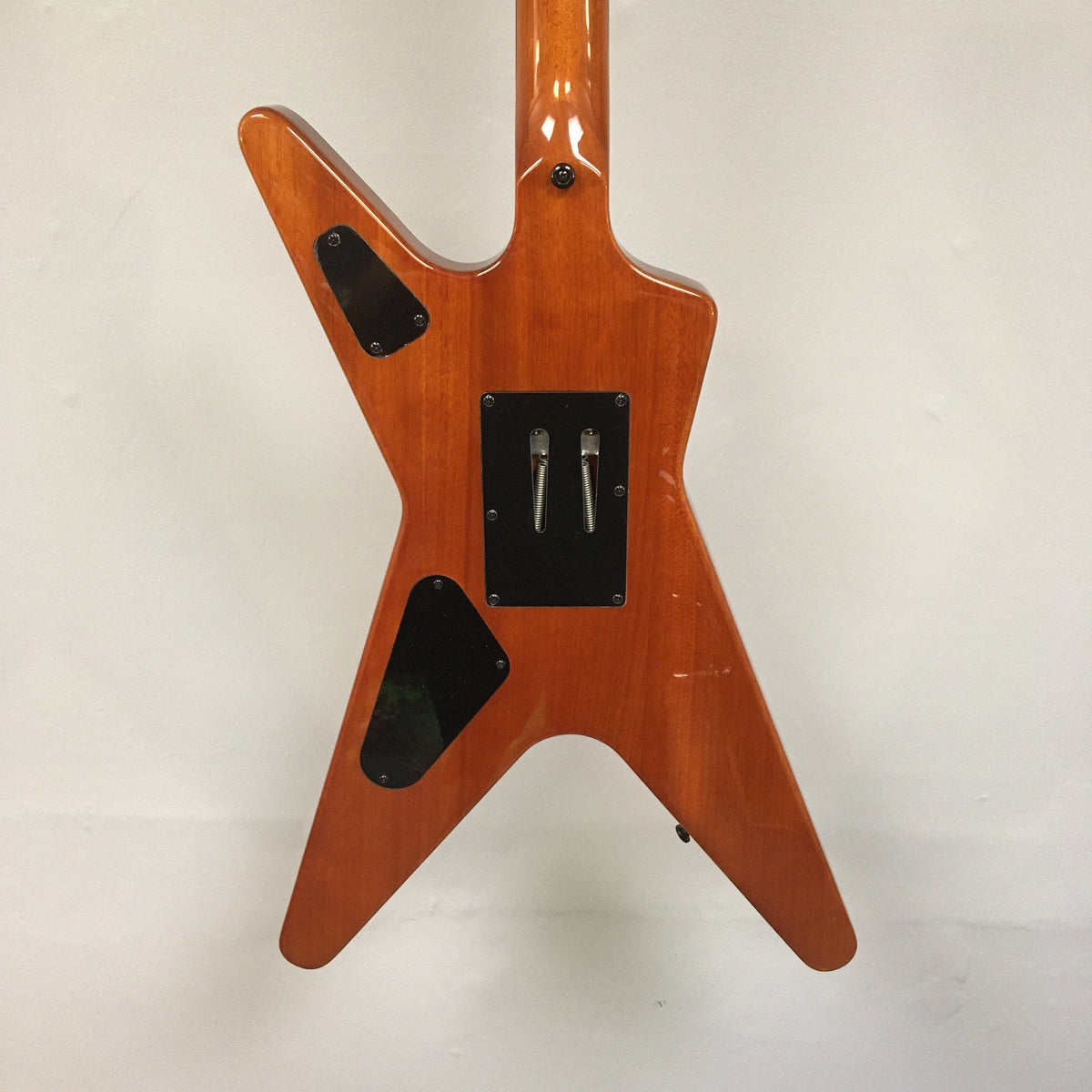 Close-up of the Dean Dimebag Dime Slime ML electric guitar, showcasing its Floyd Rose tremolo bridge and Dime Slime finish.