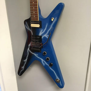 Dean Dime From Hell ML electric guitar with white knobs and V headstock, featuring a Floyd Rose bridge and unique graphic design.