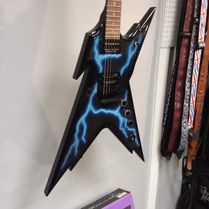 Dean Razorback Lightning B Stock electric guitar on a wall, featuring a lightning graphic and close-up of strings and headstock.