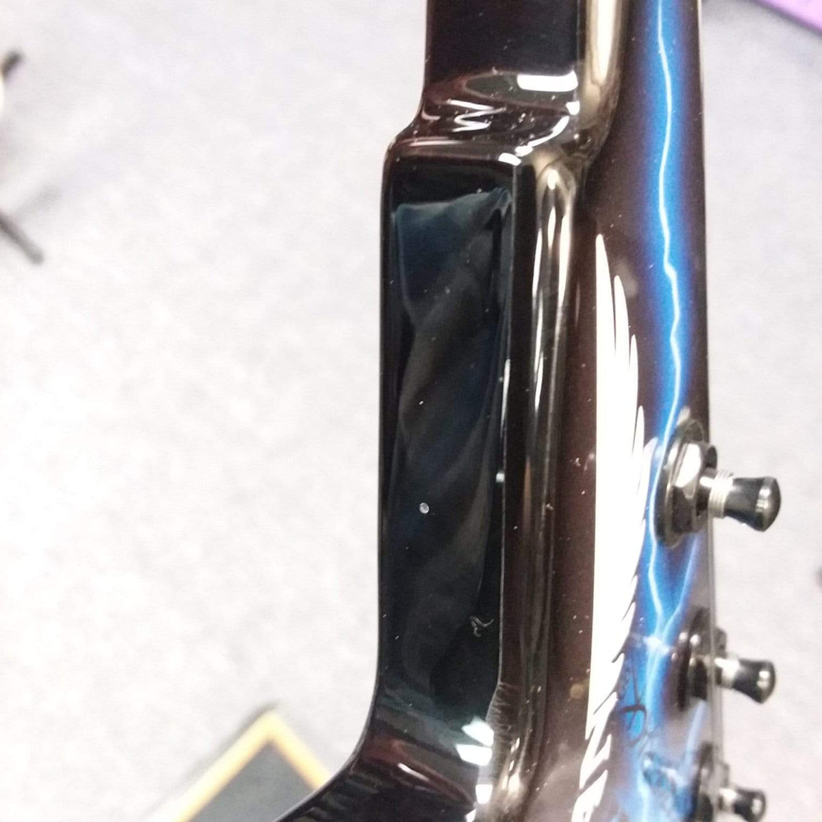 Close-up of the Dean Razorback Lightning B Stock guitar headstock, showcasing its professional-grade build and minor cosmetic blemish.